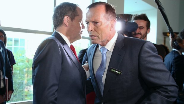 Opposition Leader Bill Shorten whispers to then prime minister Tony Abbott earlier this year.