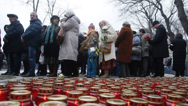 Candles glow as people gather for a memorial service before the funeral of slain opposition figure Boris Nemtsov in Moscow.