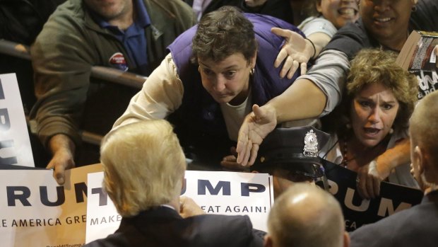 A sensation: Donald Trump signs autographs at the conclusion of a campaign event.