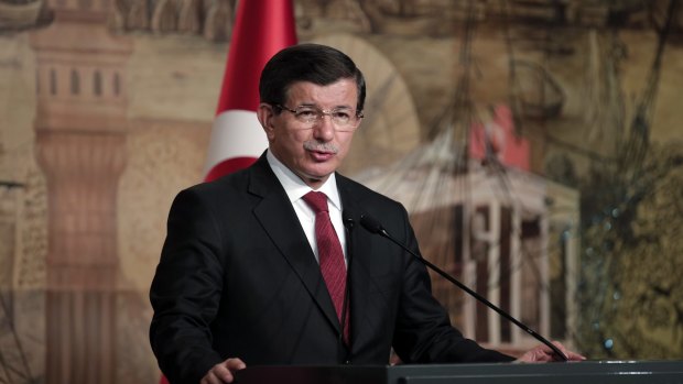 Turkish Prime Minister Ahmet Davutoglu talks during a joint news conference with Germany's Chancellor Angela Merkel.