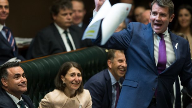 The new Deputy Premier, John Barilaro, watches Premier Mike Baird throw some papers across the room in parliament after he was appointed the NSW Nationals leader, in Sydney. 