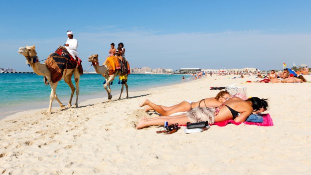 Tourists on a beach in Dubai. Dress codes are more relaxed in many Middle Eastern countries than you might think.