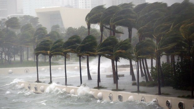 Waves crash over a seawall in Miami, Florida.