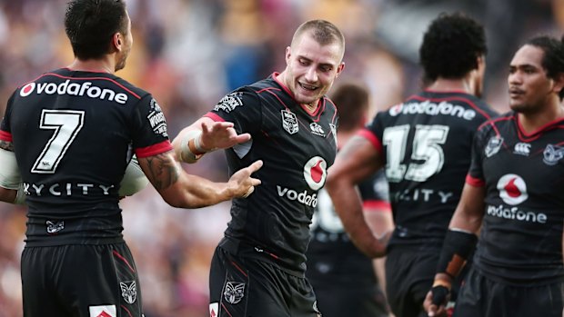 Local hero: Foran celebrates with teammates after scoring a try.