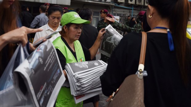 Locals snap up souvenir editions of newspapers featuring King Bhumibol.