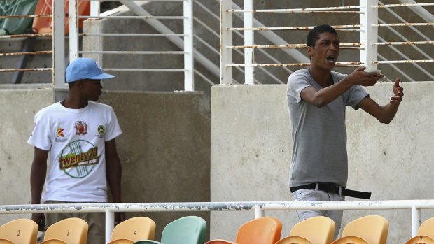 Locals argue over match tickets during an Australian nets session at Sabina Park.