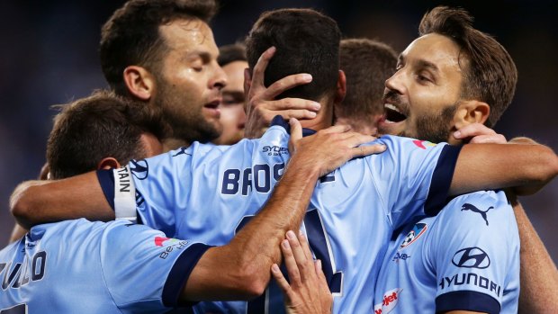 Momentum: Alex Brosque of Sydney FC celebrates with teammates after scoring the opening goal.