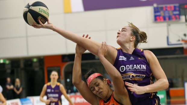Full stretch: Boomer Kelly Bowen goes up and over Townsville's Natasha Cloud.
