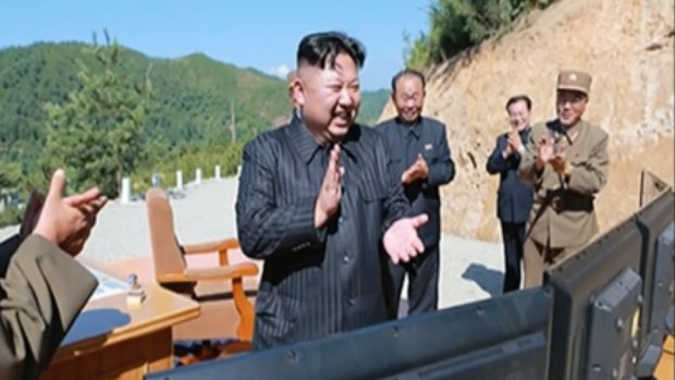 North Korea leader Kim Jong Un, centre, applauds after the launch of an intercontinental ballistic missile last month.