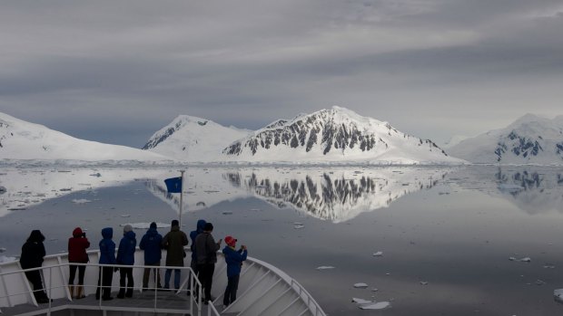 Eco-tourists aboard a cruise ship observe reflections in Crystal Sound. 