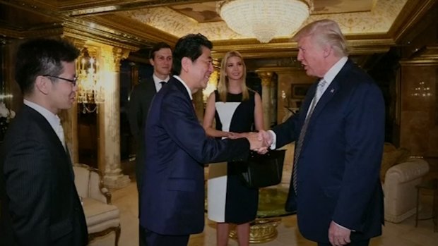 Japan PM Shinzo Abe and Donald Trump meet in the presence of Trump's daughter, Ivanka.