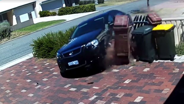 CCTV of the car crashing into the letterbox.
