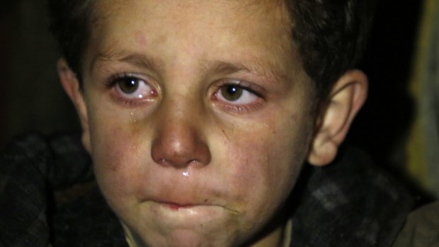 A young boy waits to be evacuated from Madaya.