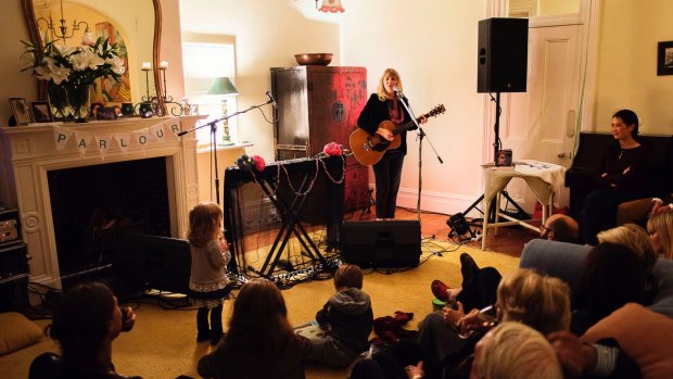 The loungeroom doubles as a stage as Sally Seltmann performs at a housewarming party. 








