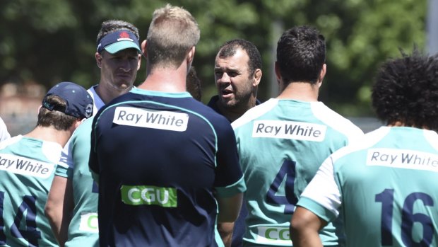 Watch your back: Michael Cheika talks to his squad.