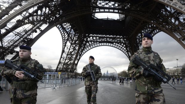 High alert: French soldiers guard the Eiffel Tower in Paris - a city on edge after recent terror attacks. 
