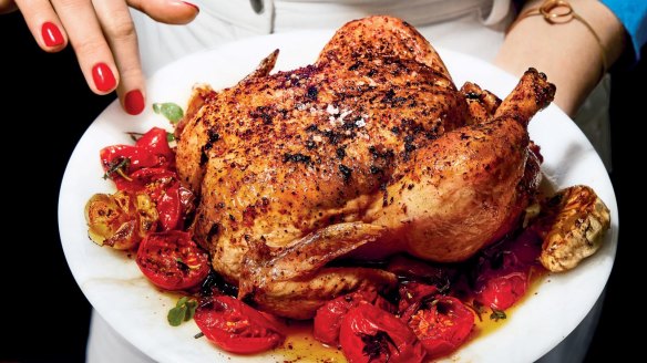 Roman's signature red nails and roast chicken star on the cover of her second cookbook, Nothing Fancy.