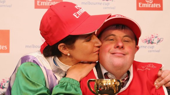 Michelle Payne celebrates her winning ride with brother and strapper Stephen Payne.