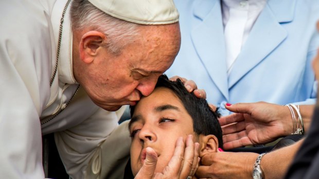 Pope Francis kisses and blesses Michael Keating, 10, of Philadelphia, when he was in the US last month. Michael has cerebral palsy.