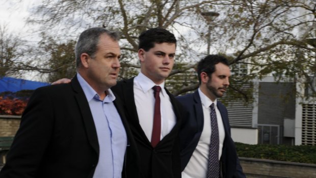Jack Toby Mitchell (centre) leaves court with his father (left) and solicitor Adrian McKenna.