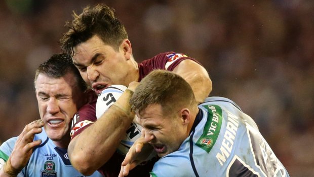 NSW players Paul Gallen and Trent Merrin put the squeeze on Maroon Aidan Guerra.