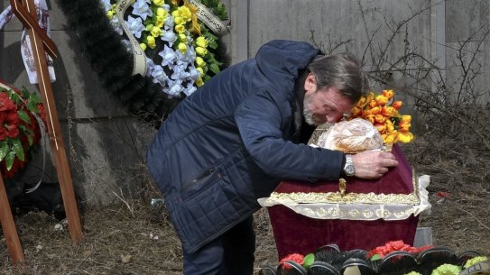 A relative mourns over the coffin with the body of 3 year-old Mykola Goryainiv, who died with his parents as they were driving a car trying to evacuate from a fighting zone in Kharkiv region, during a funeral ceremony in Kramatorsk, Ukraine, Wednesday, March 30, 2022. (AP Photo/Andriy Andriyenko)