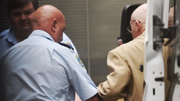 Roger Rogerson being led into the Supreme Court in Sydney on Monday.
