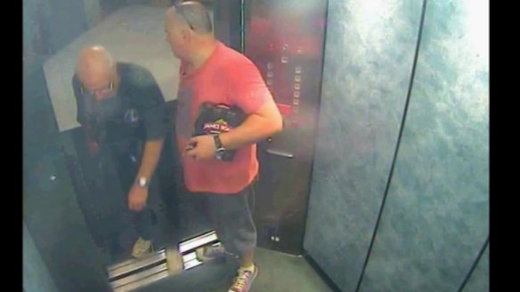 Glen McNamara, holding a six pack of beer under his arm, with Roger Rogerson in the lift of Nr McNamara's Cronulla apartment on May 20, 2014. 