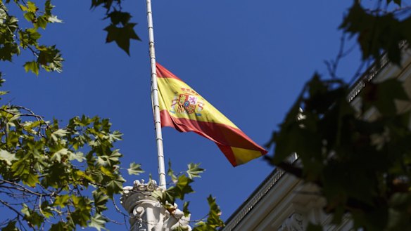The Spanish flag flies at half staff above the Madrid stock exchange.