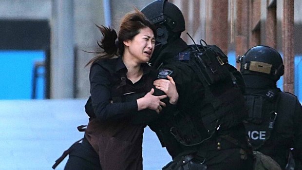 Lindt cafe waitress April Bae runs into the arms of armed tactical response police officers.