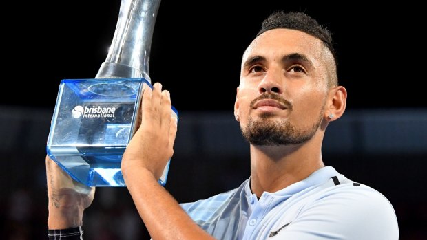 First Australian title: Nick Kyrgios holds the Brisbane International trophy aloft after dispatching American Ryan Harrison in the final.