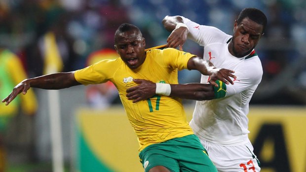 Dogged defender: Jacques Faty (right) battles for the ball with South Africa's George Maluleka during an international friendly at Moses Mabhida Stadium in Durban.