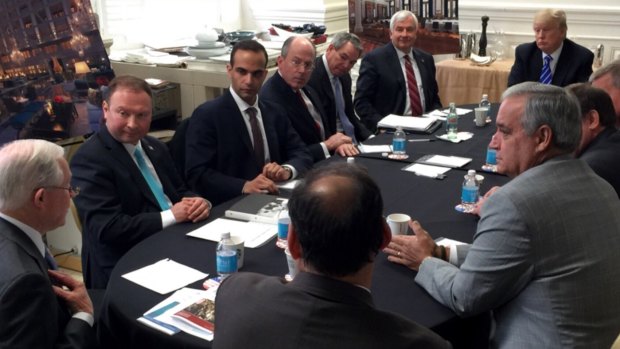 In this photo from President Donald Trump's Twitter account, George Papadopoulos, third from left, sits at a table with then-candidate Trump and others at what is labeled at a national security meeting in Washington in 2016. 