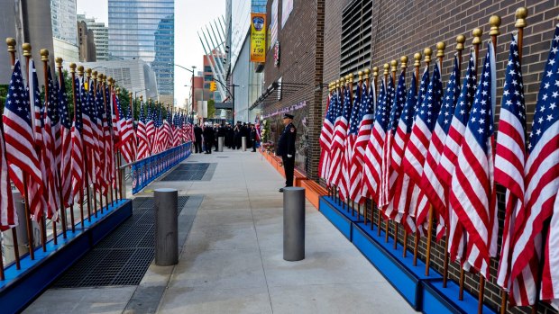 A New York firefighter stands as part of an honour guard near the World Trade Centre.