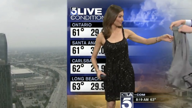 KTLA weather reporter Liberté Chan is handed a cardigan to cover herself up. 