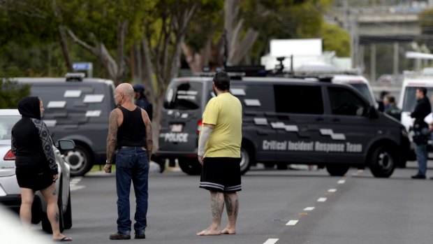 Neighbours watch police during the siege in Frankston on Tuesday morning.