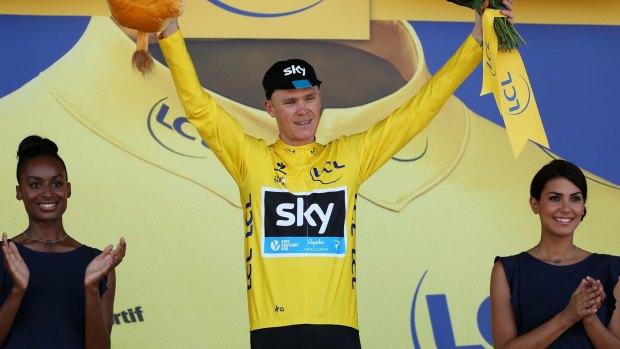 Chris Froome of Great Britain and Team Sky celebrates as he retains the yellow jersey following stage eight of the 2015 Tour de France.