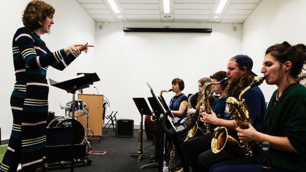 Ellen Kirkwood rehearses the sax section of  the Sirens big band. 
