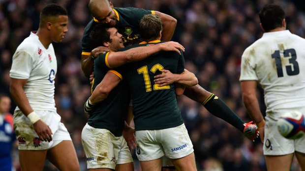Jan Serfontein celebrates with teammates after scoring South Africa's opening try.