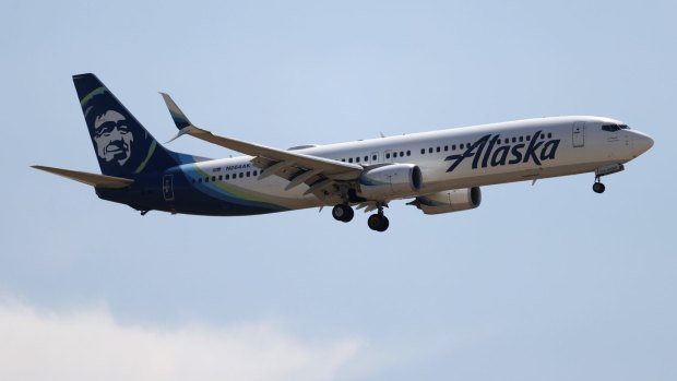 Fourteen passengers have been banned from Alaska Airlines after rowdy behaviour on a flight from Washington DC following the Capitol Building riot.