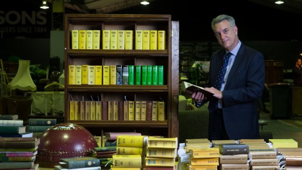 Malcolm Moir prepares to farewell items from his father Ian's collection of cricket memorabilia, including a complete set of Wisden Almanacks.