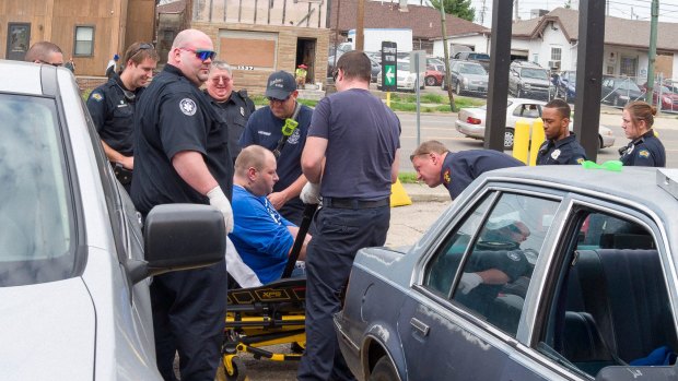 Dayton police and paramedics revive a man who has overdosed.