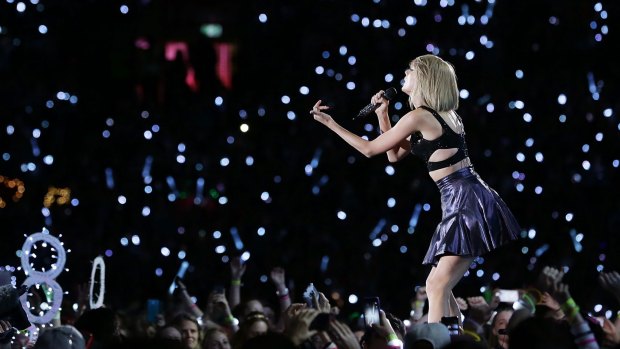 Ocean of blue light: Taylor Swift performs during her 1989 World Tour.