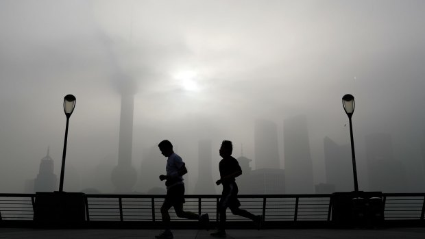Joggers along Shanghai's famous Bund: China's pollution is on the rise.