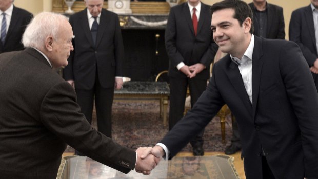 Anti-austerity leader: Greece's Prime Minister Alexis Tsipras, right, shakes hands with Greek President Karolos Papoulias at the Presidential Palace.