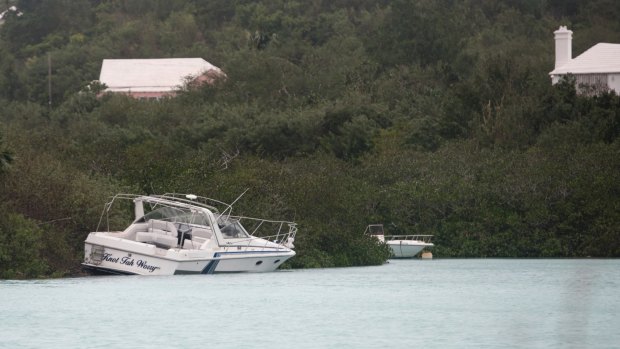 A boat that broke from its moorings lays ashore at Ferry Reach, St. Georges, Bermuda.