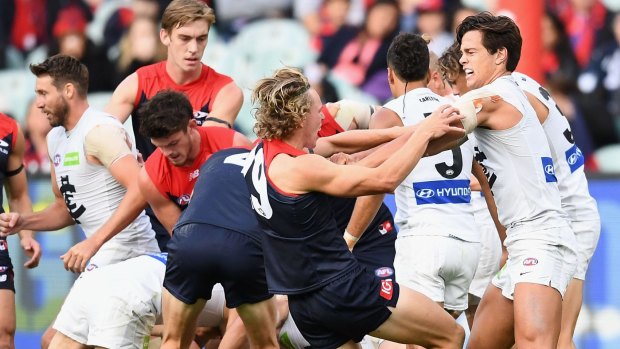 Melbourne and Carlton players wrestle during the round two match on Sunday which resulted in suspensions for Jesse Hogan and Jordan Lewis. 