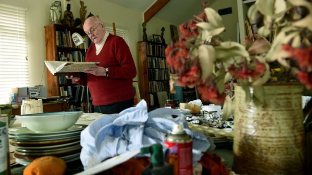 Australian artist John Olsen with the most recent  of the 58  journals he is donating to the National Library of Australia.
