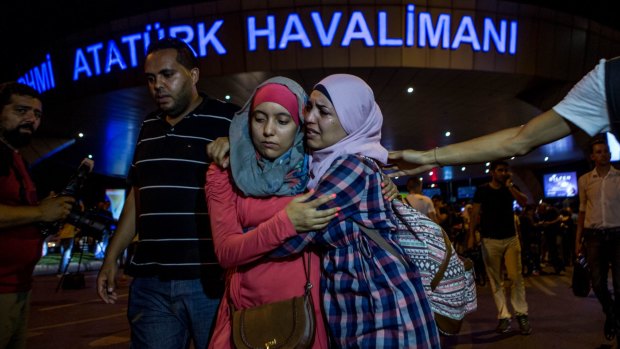 Passengers leave Istanbul's Ataturk airport after a terrorist attack killed dozens.