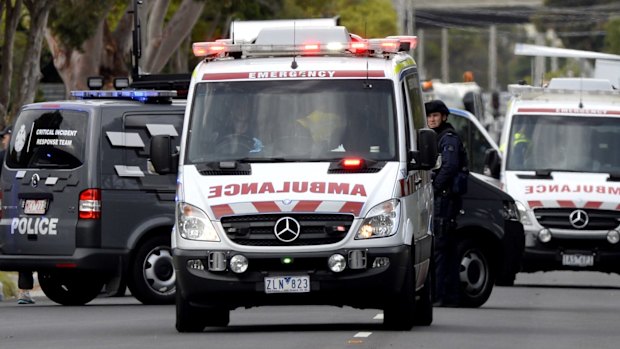 An ambulance leaving the scene of a siege in Frankston after what's believed to be gun shots were heard.